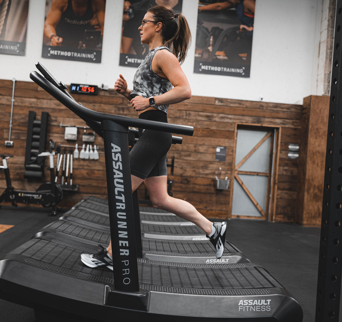The coach is running on a treadmill.